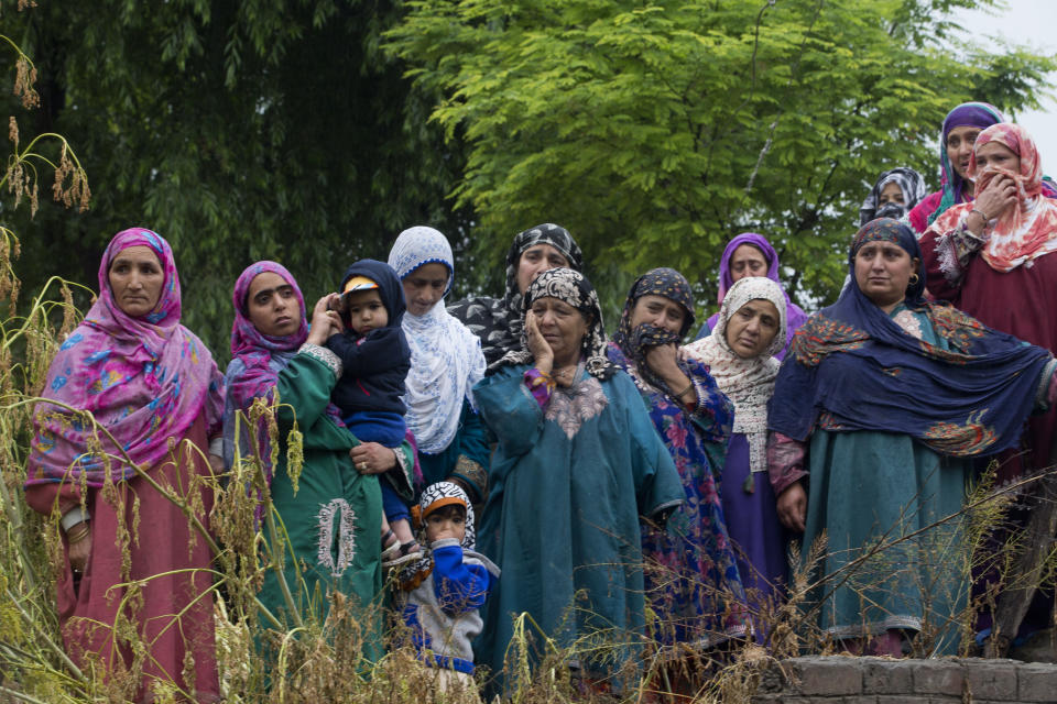 Kashmiri villagers watch the funeral procession of Zakir Musa, a top militant commander linked to al-Qaida, as it rains in Tral, south of Srinagar, Indian controlled Kashmir, Friday, May 24, 2019. Musa was killed Thursday evening in a gunfight after police and soldiers launched a counterinsurgency operation in the southern Tral area, said Col. Rajesh Kalia, an Indian army spokesman. (AP Photo/Dar Yasin)