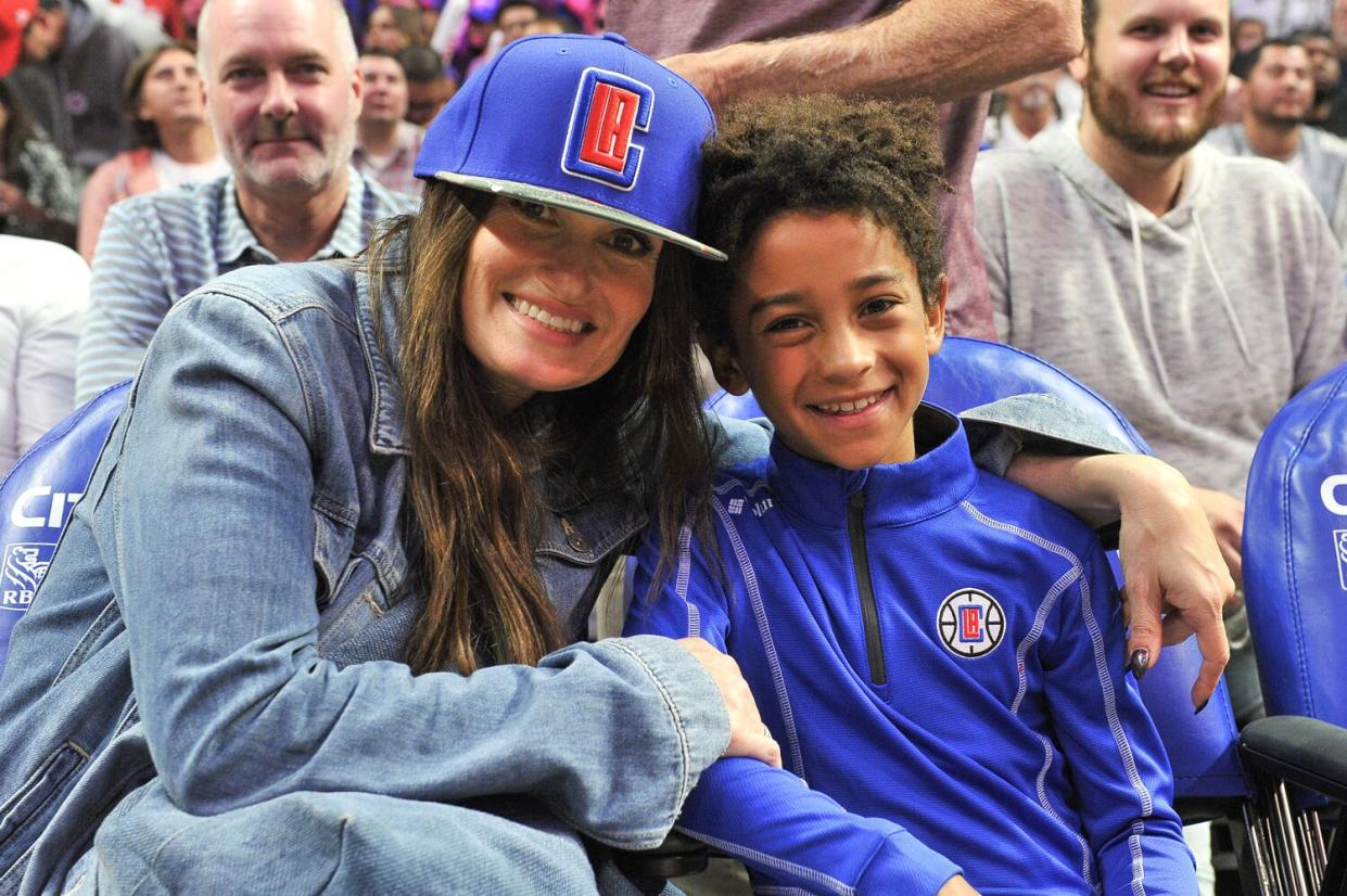 Idina Menzel and Walker Nathaniel Diggs attend a basketball game between the Los Angeles Clippers and the Charlotte Hornets at Staples Center on October 28, 2019 in Los Angeles, California.