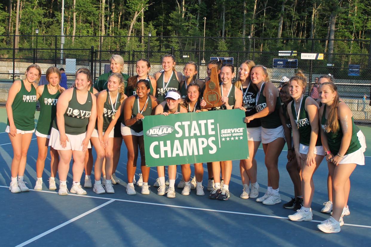 The Dover High School girls tennis team celebrates its second straight Division I state championship in June 2023 following a 5-4 win over Derryfield at Southern New Hampshire University in Manchester.