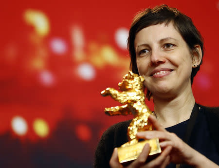 Director, screenwriter, editor and producer Adina Pintilie poses with her Golden Bear award for Best Film Touch Me Not at the news conference after the awards ceremony at the 68th Berlinale International Film Festival in Berlin, Germany, February 24, 2018. REUTERS/Fabrizio Bensch