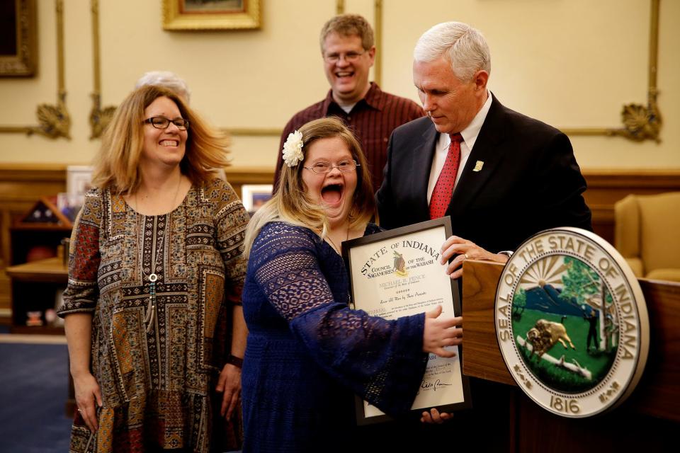 Indiana Governor Mike Pence presents Mickey Deputy with the Sagamore of the Wabash inside his office Monday, April 11, 2016, at the Indiana Statehouse. Jenny and Michael, Mickey's mother and father, and Brad, her brother, as well as her grandparents Gil and Linda Deputy and Joann Bennett stood by her as she received the state's highest civilian honor.