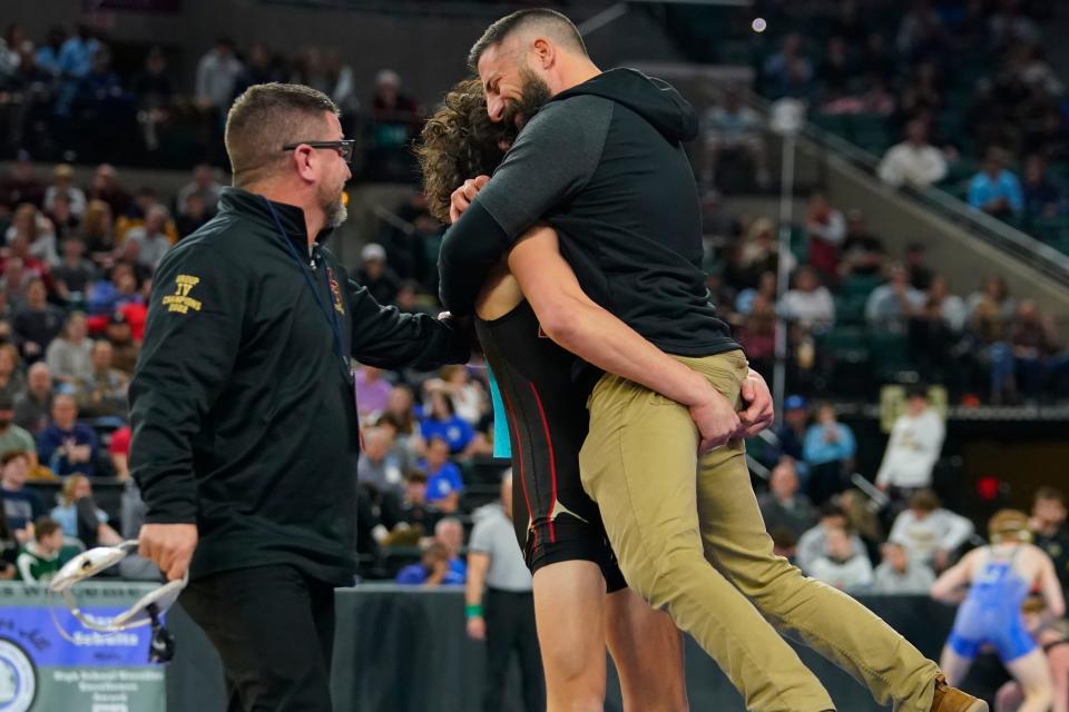 Jack Bastarrika of Mount Olive lifts up his coach Joe Barchetto as coach Bill Romano looks on after winning his 132-pound semifinal bout on day two of the NJSIAA state wrestling tournament in Atlantic City on Friday, March 3, 2023.