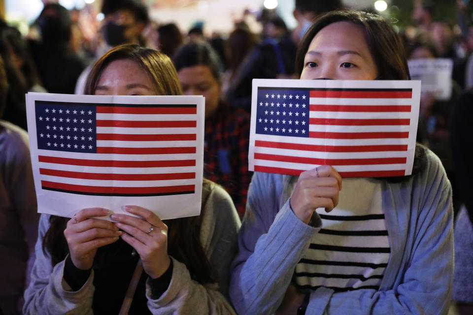 Protester holds U.S. flags during a demonstration in Hong Kong, Thursday, Nov. 28, 2019. China’s fury over President Donald Trump’s decision to sign legislation supporting human rights in Hong Kong is evident. What’s less clear what “countermeasures” Beijing may take in response to what it said Thursday were “extremely evil” and dangerous moves. (AP Photo/Vincent Thian)