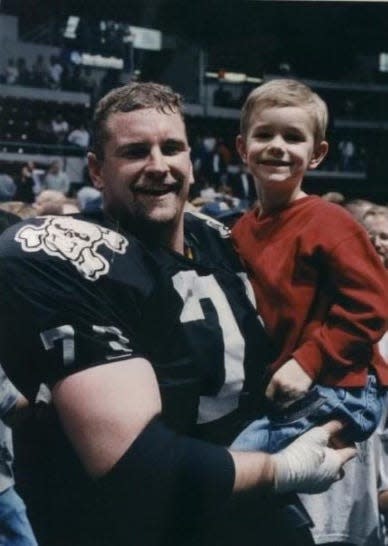 Cam Pepper, a charter member of the Indoor Football League Peoria Pirates, holds his son, Taybor Pepper, after the inaugural Pirates game in Carver Arena on April 2, 1999. Taybor Pepper now is an NFL long-snapper and in the Super Bowl with the 49ers on Feb. 11, 2024.