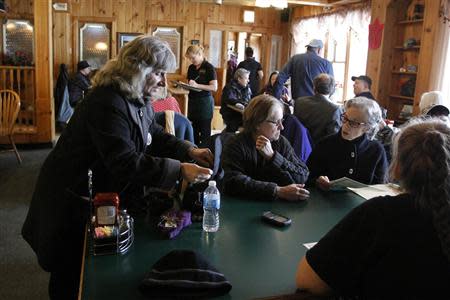 Anti-fracking activist Vera Scroggins (R) shares a moment with friends inside a restaurant in Montrose, Pennsylvania, March 24, 2014. REUTERS/Eduardo Munoz