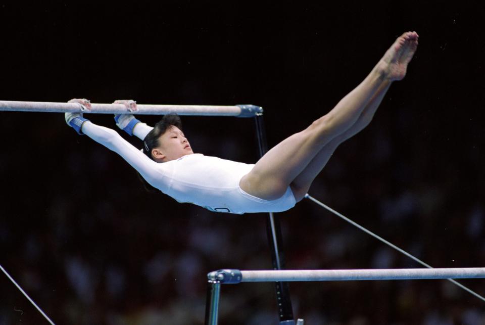 28 Jul 1996: Amy Chow of the USA swings on the parellel bars during her routine at the Georgia Dome in the 1996 Olympic Games in Atlanta, Georgia. Mandatory Credit: Pascal Rondeau  /Allsport