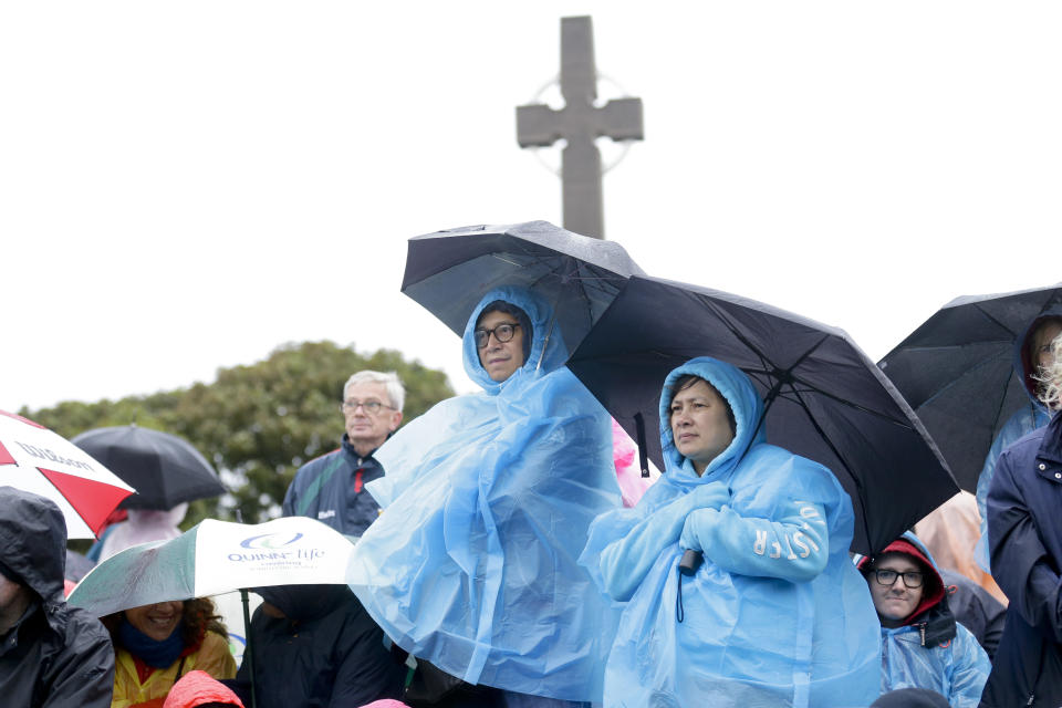 People wait for the arrival of Pope Francis in front of the Knock Shrine, in Knock, Ireland, Sunday, Aug. 26, 2018. Pope Francis is on a two-day visit to Ireland. (AP Photo/Peter Morrison)