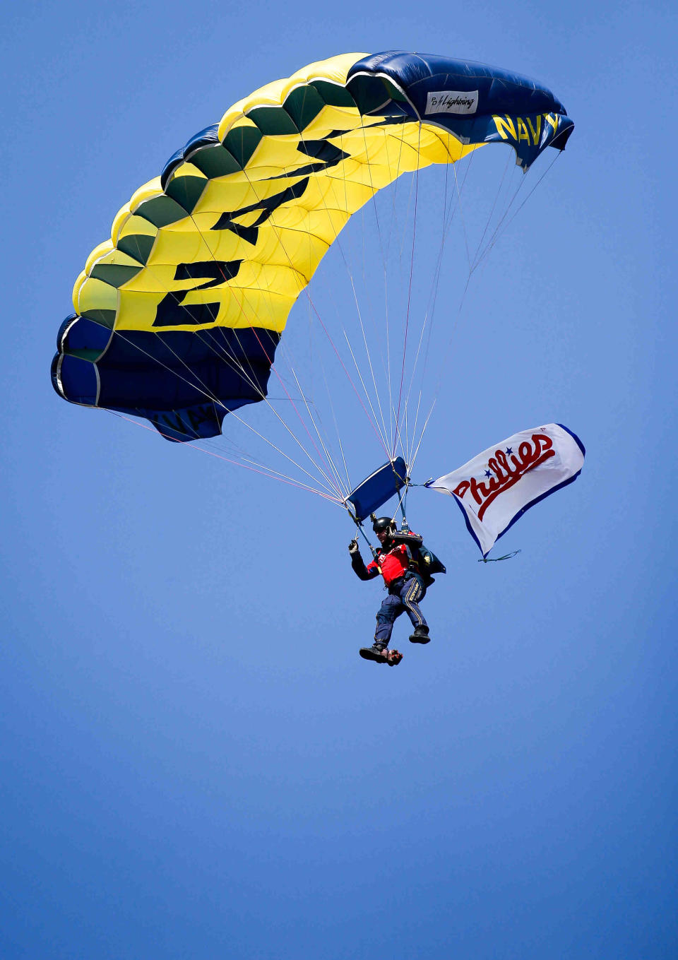 Fans look up into the sky as members of the Navy parachute down into Citizens Bank Park in 2015.