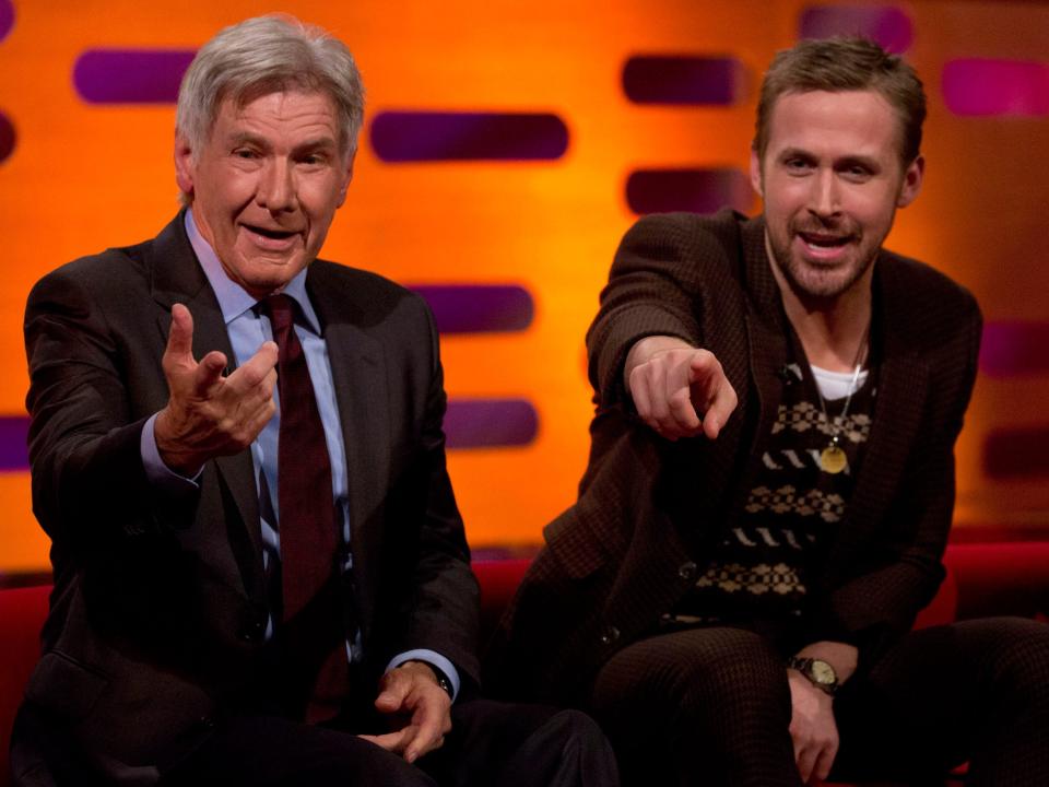 Harrison Ford and Ryan Gosling both smile and point at the camera in a still from their 2017 appearance on "The Graham Norton Show."