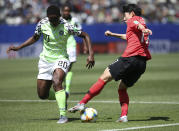 Nigeria's Chidinma Okeke, left, challenges South Korea's Lee Geum-min during the Women's World Cup Group A soccer match between Nigeria and South Korea in Grenoble, France, Wednesday June 12, 2019.(AP Photo/Laurent Cipriani)