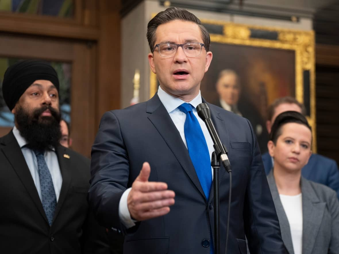 Flanked by Conservative finance critic Jasraj Singh Hallan and Conservative deputy leader Melissa Lantsman and other members of Parliament, Conservative Leader Pierre Poilievre tells reporters he intends to delay the passage of the budget unless his party's demands are met. (The Canadian Press/Adrian Wyld - image credit)