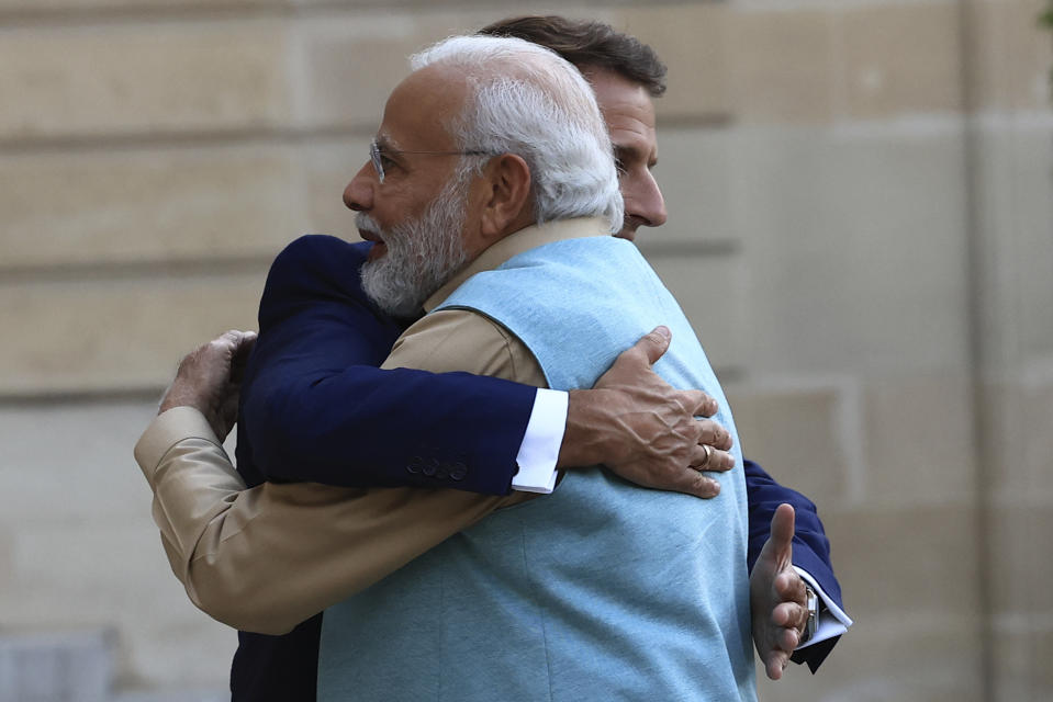 French President Emmanuel Macron hugs Indian Prime Minister Narendra Modi before a working dinner, Thursday, July 13, 2023 at the Elysee Palace, in Paris. Narendra Modi is on a two-day visit and will attend Bastille Day parade with French President Emmanuel Macron on Friday. (AP Photo/Aurelien Morissard)
