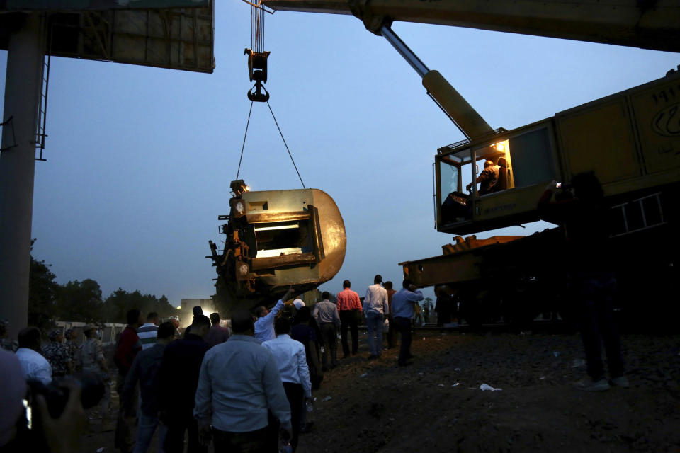 FILE - In this Sunday April 18, 2021 file photo, a crane is used to lift a part of a passenger train that derailed injuring around 100 people, near Banha, Egypt. On Tuesday, Egypt’s transportation minister said he sacked the country’s top railway official, following three train accidents in less than a month that left at least 29 people dead and some 320 injured. (AP Photo/Fadel Dawood, File)