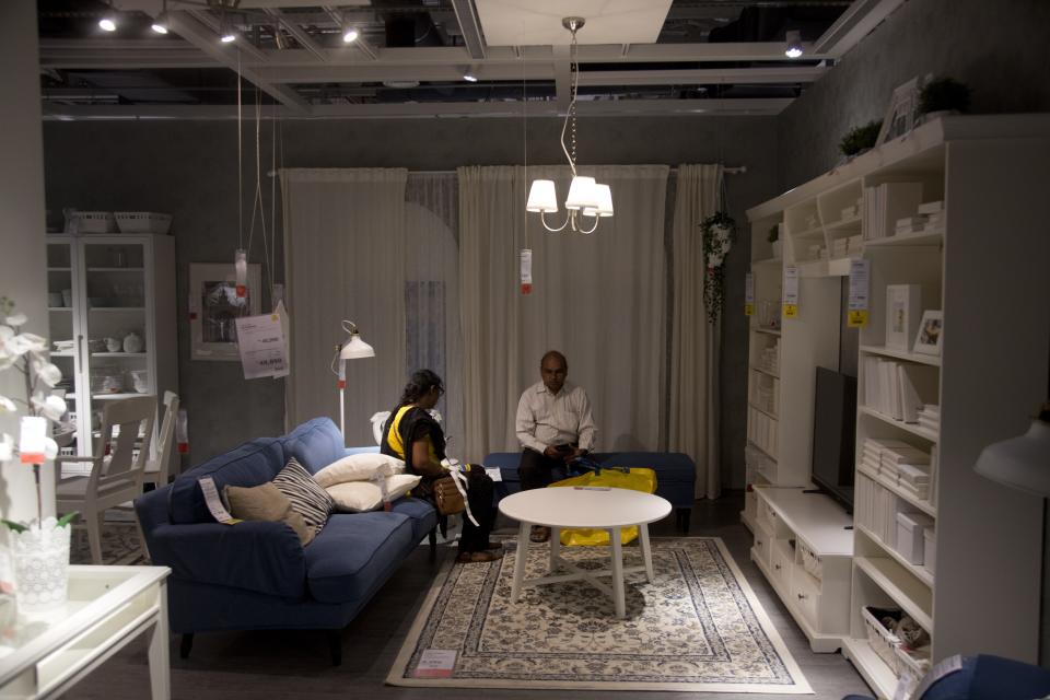 Indian customers check the furnishings inside IKEA's first store in India as it opened in Hyderabad, India, Thursday, Aug.9, 2018. Swedish home furnishings giant IKEA opened its first store in India on Thursday, five years after it received approval to invest in the country's single-brand retail sector. (AP Photo/Mahesh Kumar A.)