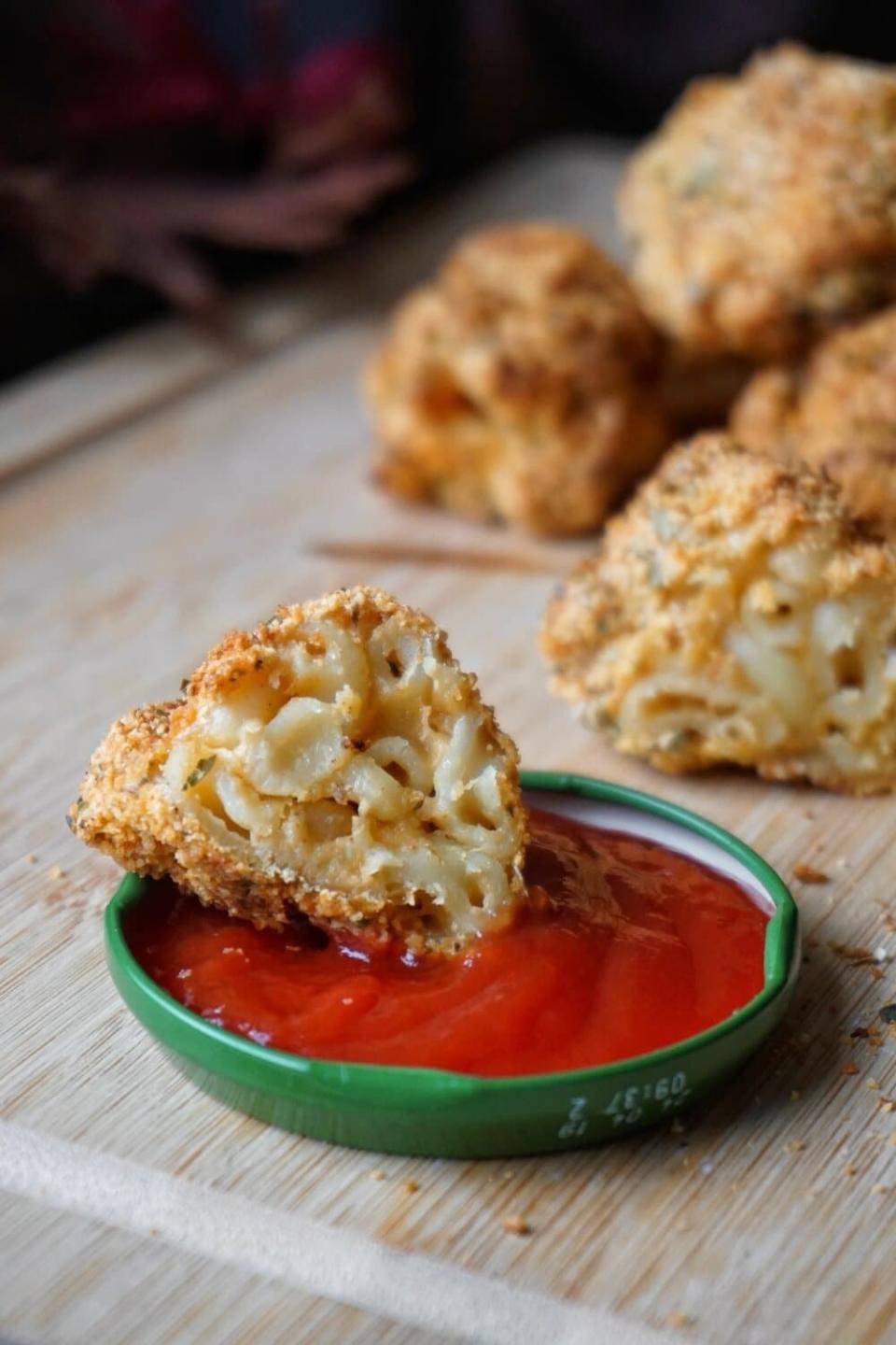 Crispy mac 'n' cheese bites with ketchup for dipping.