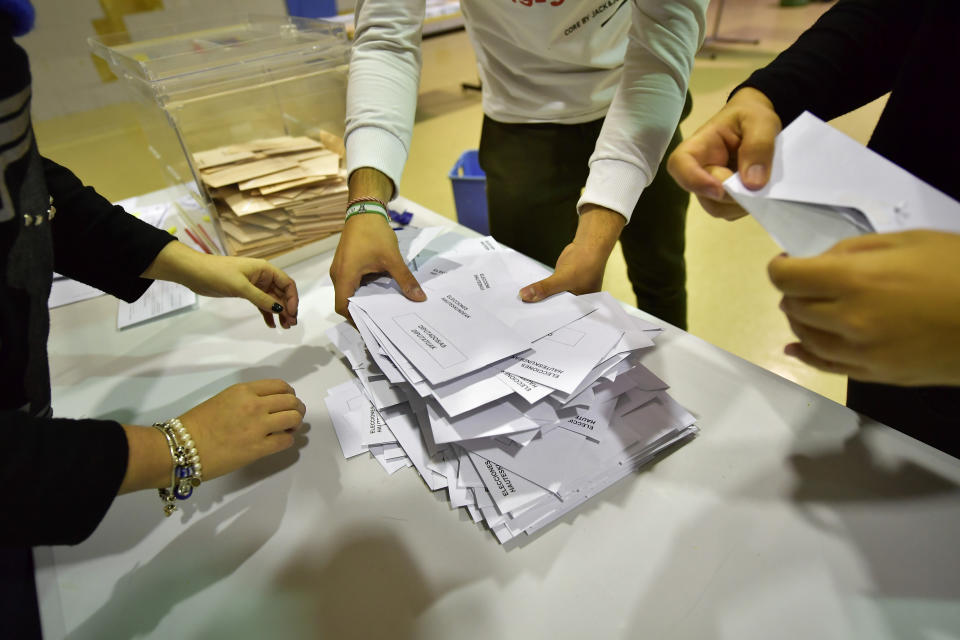 Election officials count votes at a polling station for the general election, in Pamplona, northern Spain, Sunday, Nov. 10, 2019. As Spaniards voted Sunday in the country’s fourth election in as many years, a leading leftist party pledged to help the incumbent Socialists in hopes of staving off a possible right-wing coalition government that could include a far-right party. (AP Photo/Alvaro Barrientos)