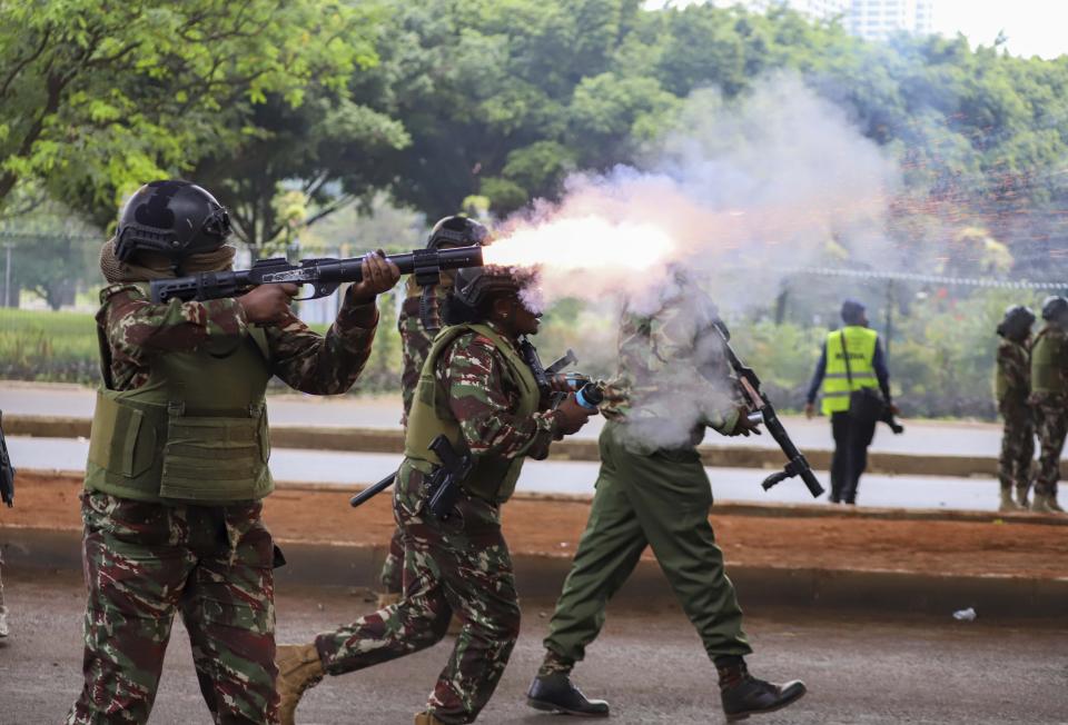 Police officers fire tear gas canisters during a protest over proposed tax hikes in a finance bill that is due to be tabled in parliament in Nairobi, Kenya, Thursday, June 20, 2024. (AP Photo/ Andrew Kasuku)