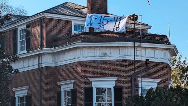 PHOTO: A banner with the numbers and initials of three University of Virginia football players, Lavel Davis Jr., Devin Chandler and D'Sean Perry, who were killed in a shooting hangs from a home near the crime scene, Nov. 14, 2022, in Charlottesville. (Nathan Ellgren/AP)