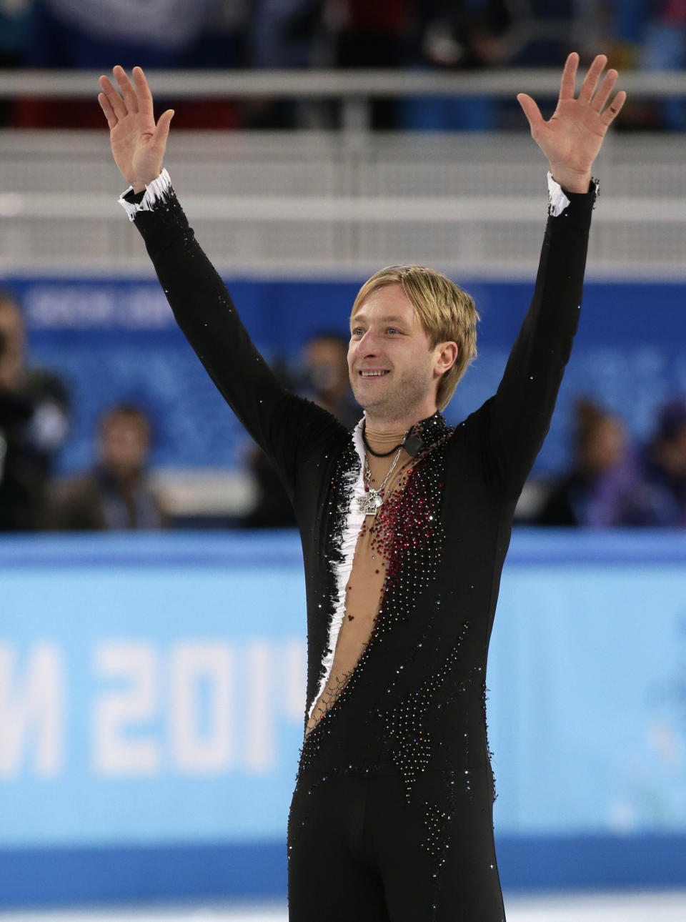 Evgeny Plyushchenko of Russia waves to spectators after competing in the men's team short program figure skating competition at the Iceberg Skating Palace during the 2014 Winter Olympics, Thursday, Feb. 6, 2014, in Sochi, Russia. (AP Photo/Bernat Armangue)