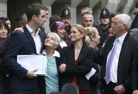 Brendan Cox, husband of MP Jo Cox, is embraced by his mother-in-law Jean Leadbeater, as his sister-in-law Kim Leadbeater and father-in-law Gordon Leadbeater look on outside the Old Bailey courthouse after the conviction and sentencing of Thomas Mair for his wife's murder, in London, Britain November 23, 2016. REUTERS/Neil Hall