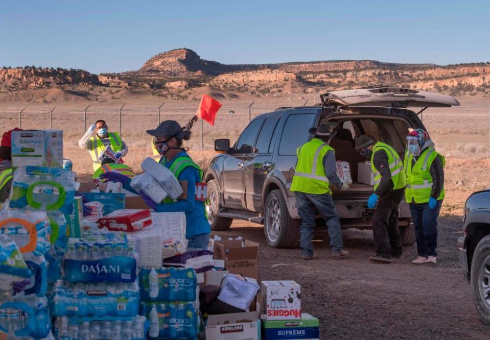 Native Americans of the Navajo Nation people, pick up supplies from a food bank set up at the Navajo Nation town of Casamero Lake in New Mexico on 20 May.