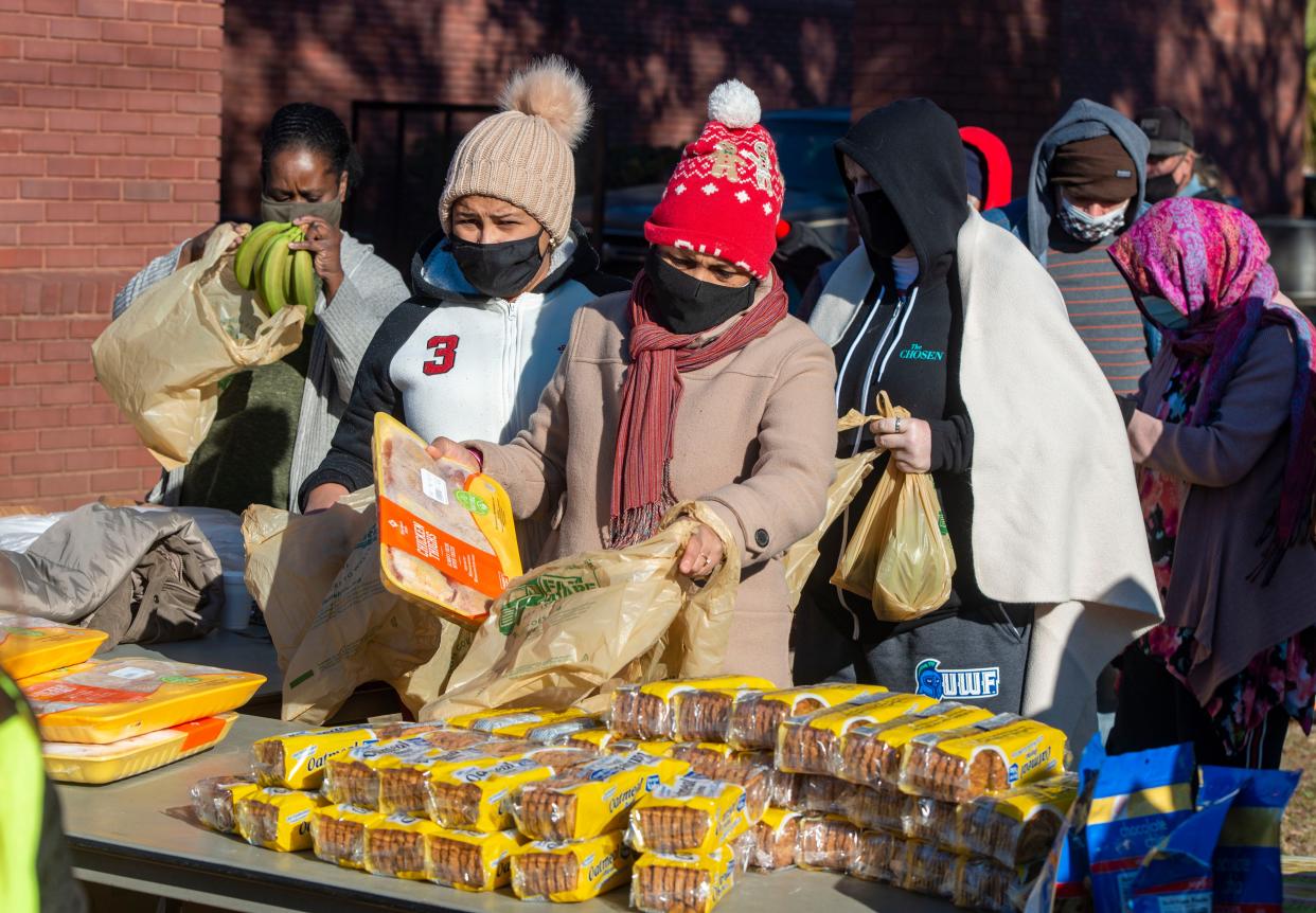 People pick up free food during the Farm Share food giveaway at Brownsville Assembly of God Church Saturday, February 20, 2021.