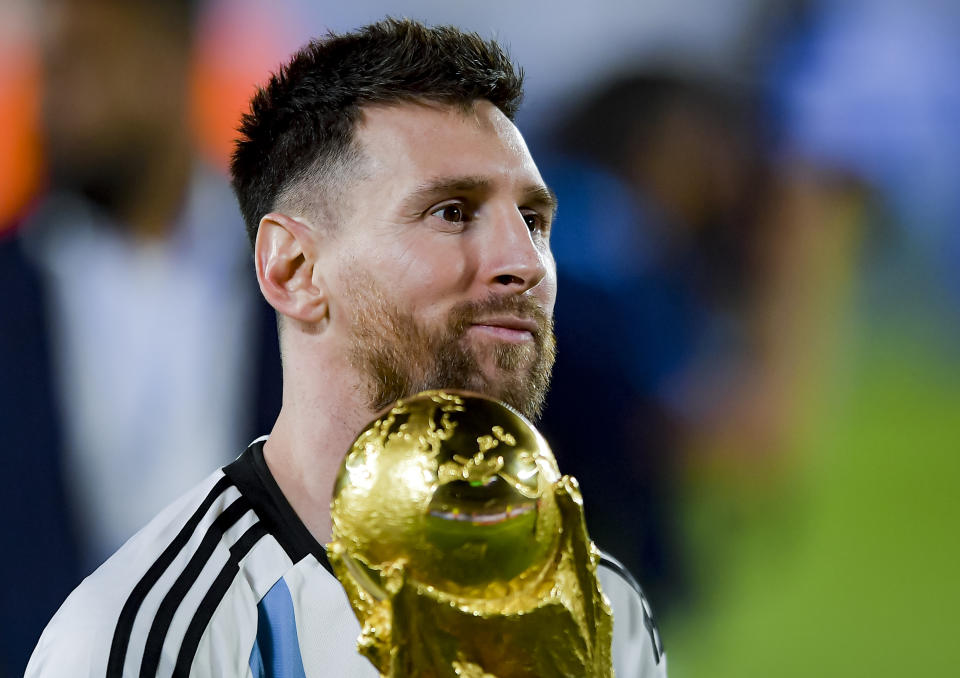 BUENOS AIRES, ARGENTINA - MARCH 23:  Lionel Messi of Argentina holds the FIFA World Cup trophy during World Champions' celebrations after an international friendly between Argentina and Panama at Estadio Mas Monumental Antonio Vespucio Liberti on March 23, 2023 in Buenos Aires, Argentina. (Photo by Marcelo Endelli/Getty Images)