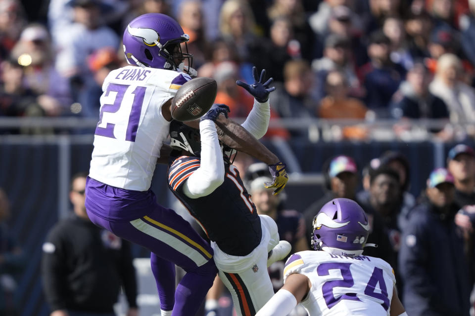 Minnesota Vikings cornerback Akayleb Evans (21) is called for interference on Chicago Bears wide receiver Tyler Scott during the second half of an NFL football game, Sunday, Oct. 15, 2023, in Chicago. (AP Photo/Charles Rex Arbogast)