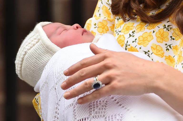 Britain's Catherine, Duchess of Cambridge holds her newly-born daughter, Princess Charlotte Elizabeth Diana