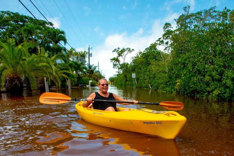 Local Kimberly Glenn, 57, kayaks up North Blackwater Lane on a trip to the store for a pack of cigarettes while the street was flooded due to the effects of Hurricane Ian at Stillwright Point in Key Largo, Florida, on Thursday, September 29, 2022.