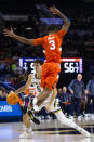 Syracuse's Judah Mintz (3) jumps up to defend Notre Dame's Cormac Ryan (5) during the second half of an NCAA college basketball game on Saturday, Dec. 3, 2022 in South Bend, Ind. (AP Photo/Michael Caterina)