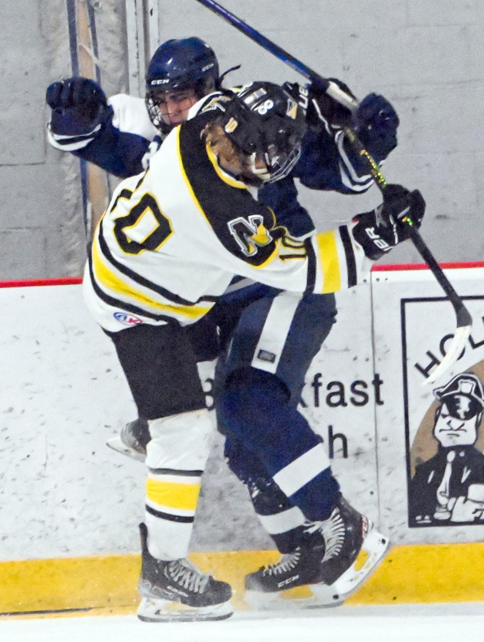 Jake Eldredge of Nauset and Luke Raferty of Mashpee/Monomoy collide along the boards during a Feb. 20th game.