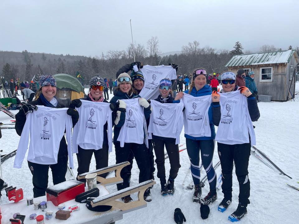 Members of the Burlington high school girls Nordic skiing team pose after securing a Division I championship three-peat on Tuesday in Ripton.