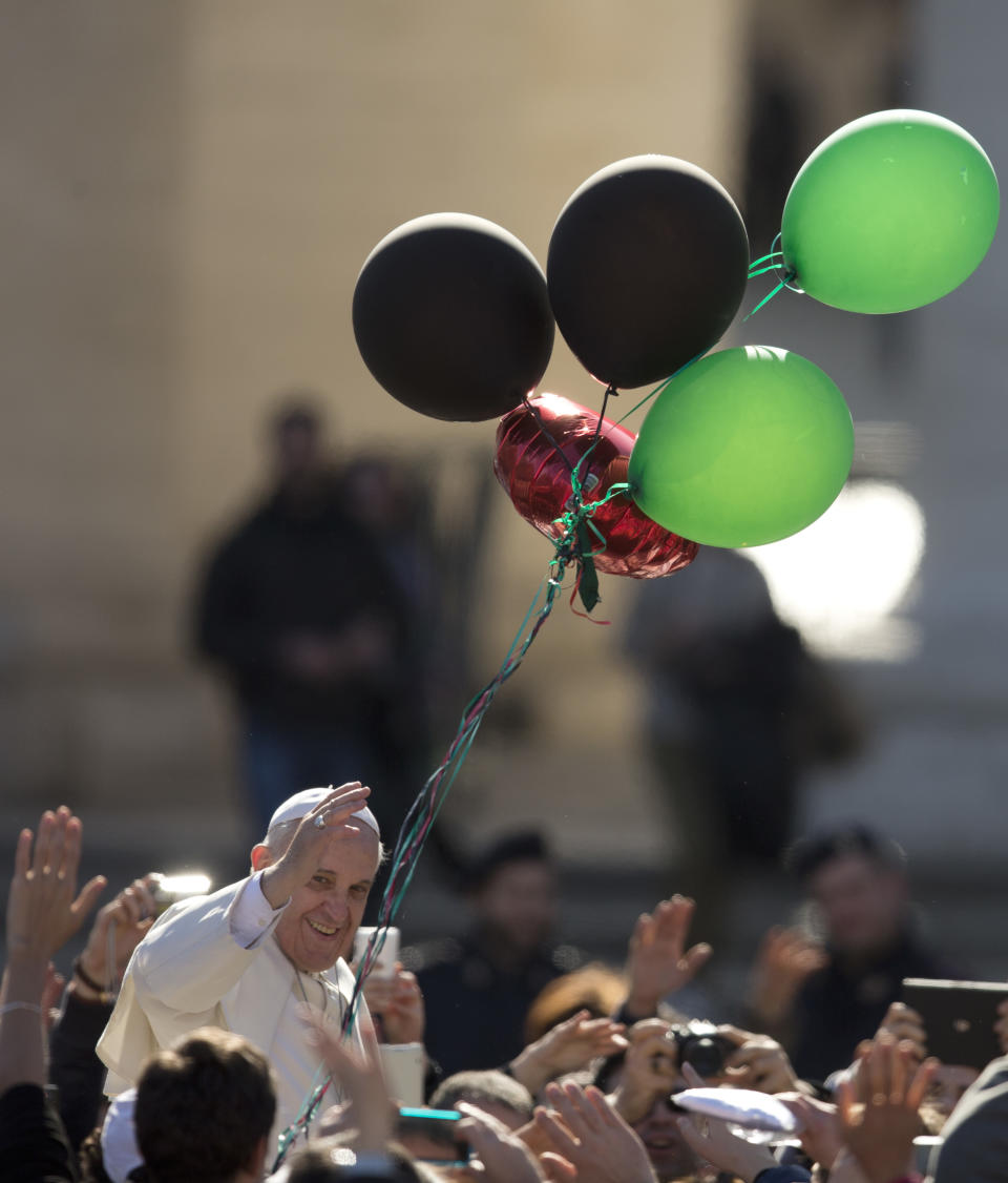 Pope Francis greets faithful as he leaves St. Peter's Square at the Vatican, Friday, Feb. 14, 2014. Pope Francis met a group of engaged couples on Valentine's Day. (AP Photo/Alessandra Tarantino)