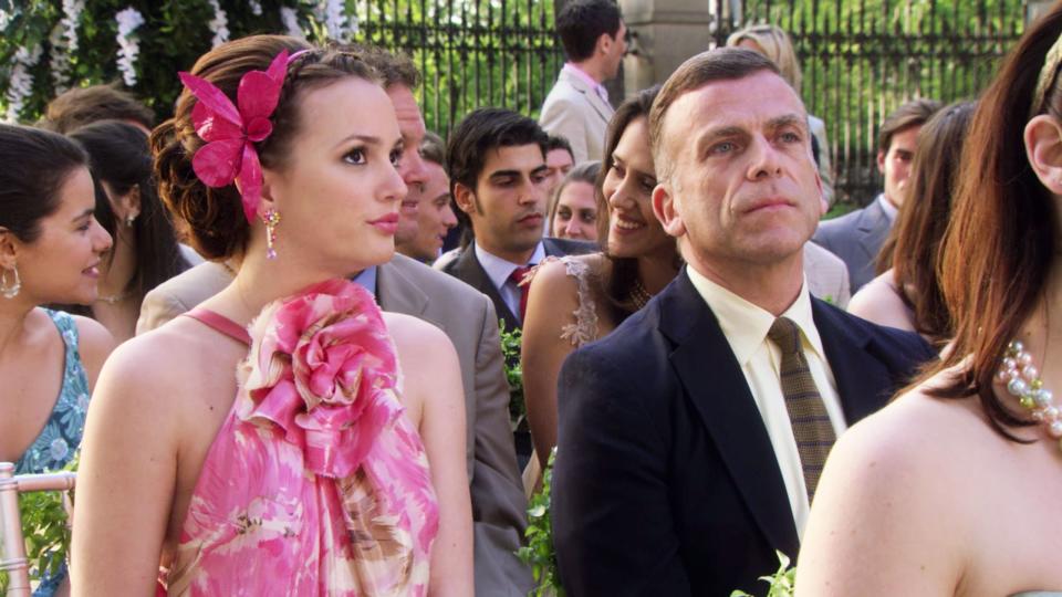 Blair matches her pink blush and lipstick to the beautiful flower head accessory that dons her updo.