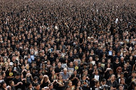 Mourners gather outside of the Grand Palace to sing for a recording of the royal anthem in honour of Thailand's late King Bhumibol Adulyadej, in Bangkok, Thailand, October 22, 2016. REUTERS/Jorge Silva