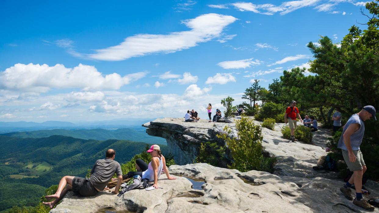 Catawba, Virginia, USA  - September 1, 2014: Hikers enjoy the view of the Appalachian Mountains from McAfee Knob on Catawba Mountain, near Roanoke, Virginia.