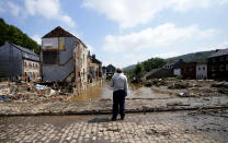 In this Saturday, July 17, 2021 file photo, a man stands on a bridge and surveys the damage after flooding in Pepinster, Belgium. Scientists say there’s something different this year from the recent drumbeat of climate weirdness. This summer a lot of the places hit by weather disasters are not used to getting extremes and many of them are wealthier, which is different from the normal climate change victims. That includes unprecedented deadly flooding in Germany and Belgium, 116-degree heat records in Portland, Oregon and similar blistering temperatures in Canada, along with wildfires. Now Southern Europe is seeing scorching temperatures and out-of-control blazes too. And the summer of extremes is only getting started. Peak Atlantic hurricane and wildfire seasons in the United States are knocking at the door. (AP Photo/Virginia Mayo, File)