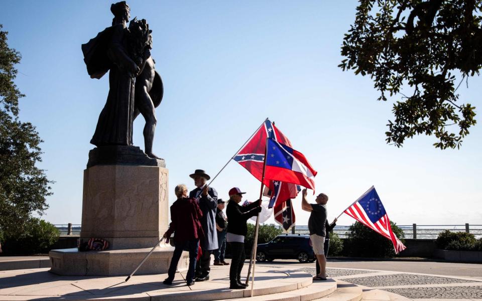 Members of a group called Flags of the South hold a protest in front of The Confederate Defenders of Charleston statue at The Battery Charleston, South Carolina - AFP