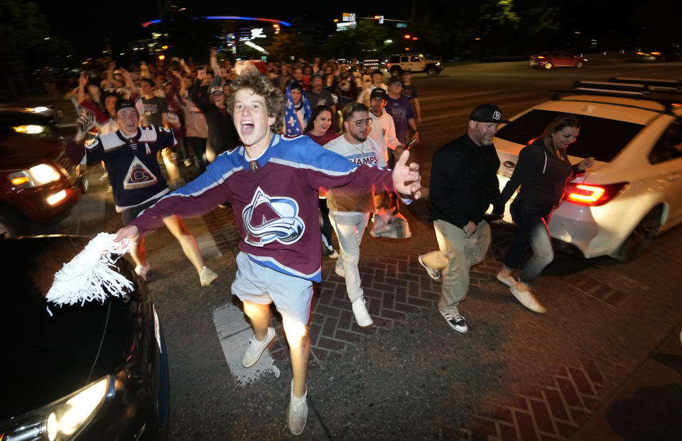 Fans cheer as they exit Ball Arena after the Colorado Avalanche defeated the Tampa Bay Lightning in Game 6 of the Stanley Cup Final to claim the NHL hockey championship Sunday, June 26, 2022, in Denver. (AP Photo/David Zalubowski)