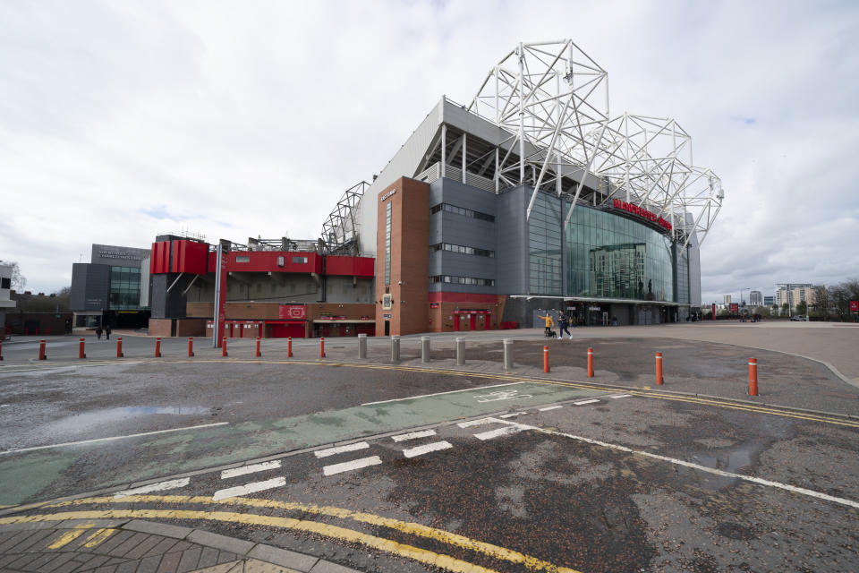 Almost empty stadium area around Manchester United's Old Trafford Stadium, Saturday, March 14, 2020, where Manchester City was due to play Burnley in an English Premier League soccer match Saturday March 14, 2020, after all English soccer games were cancelled due to the spread of the COVID-19 Coronavirus. For most people, the new COVID-19 coronavirus causes only mild or moderate symptoms, but for some it can cause more severe illness.(AP Photo/Jon Super)