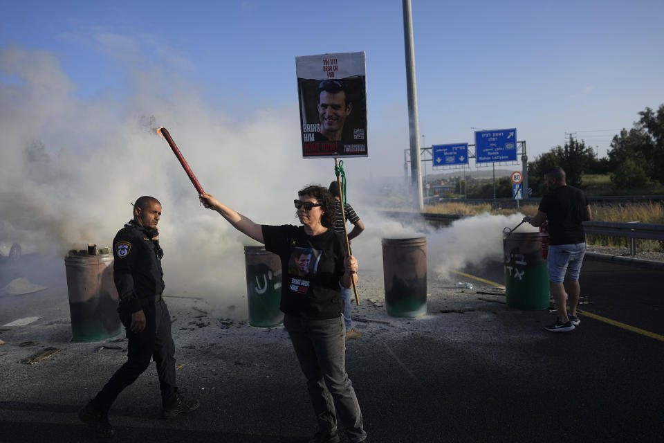 Relatives of hostages held in the Gaza Strip block Highway 1, the main route linking Tel Aviv and Jerusalem, to call for a deal to release all hostages, Friday, April 19, 2024. (AP Photo/Ohad Zwigenberg)