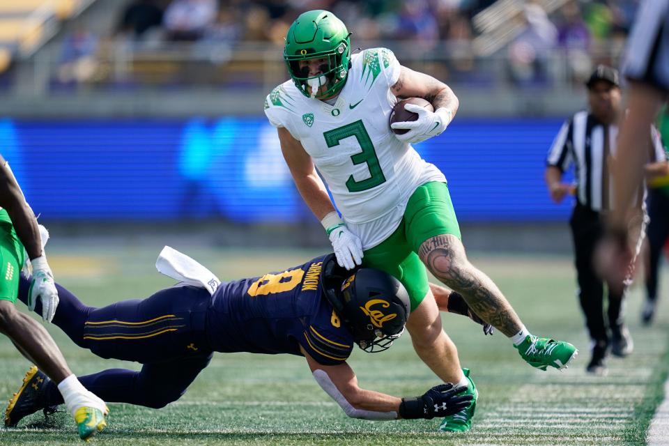 Oregon tight end Terrance Ferguson (3) runs after a catch as California linebacker Jackson Sirmon (8) attempts a tackle during the first half of the game in Berkeley, Calif., Saturday, Oct. 29, 2022.