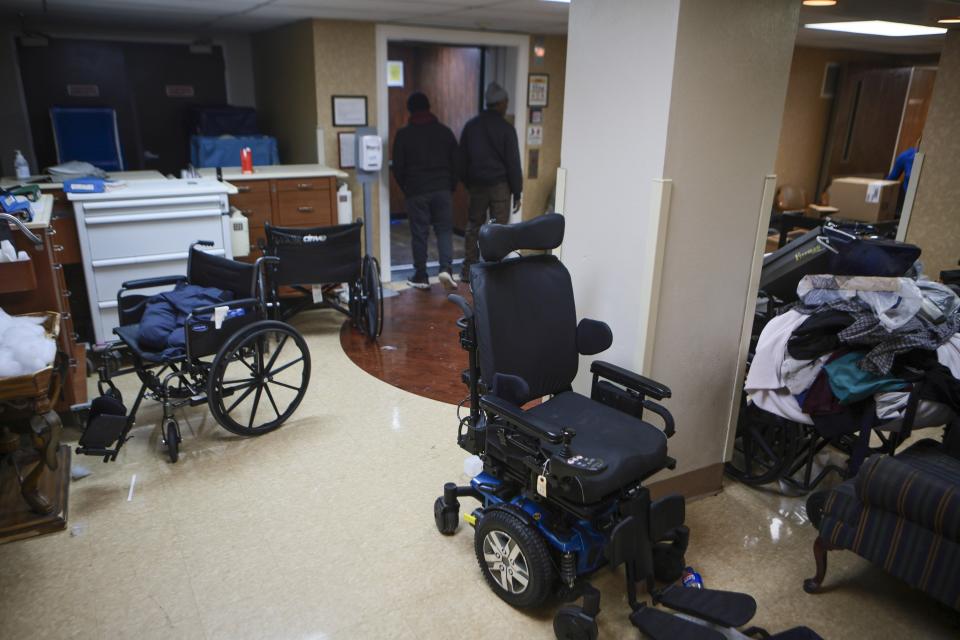 Mobility equipments and other things are left near the lobbyof Northview Village Nursing Home in St. Louis on Saturday, Dec. 16, 2023. The living facility closed suddenly, much to the outrage of employees, volunteers and relatives of residents who returned to find their belongings and information of the whereabouts of loved ones. (Vanessa Abbitt/St. Louis Post-Dispatch via AP)
