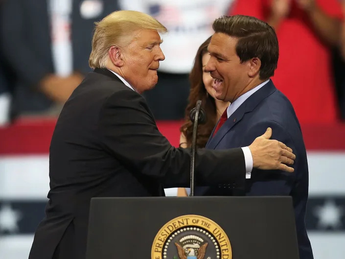 Then-President Donald Trump greets then-Florida Republican gubernatorial candidate Ron DeSantis during a campaign rally at the Hertz Arena on October 31, 2018 in Estero, Florida.