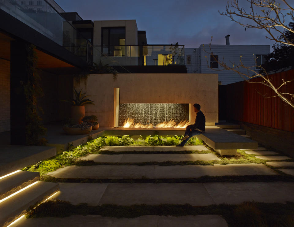 outdoor fire place in an urban garden with stone patio