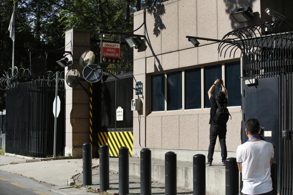 Members of the media take pictures of the damage to a security booth by a shot fired, outside the U.S. Embassy in Ankara, Turkey, Monday, Aug. 20, 2018. Shots were fired at a security booth outside the embassy in Turkey's capital early Monday, but U.S. officials said no one was hurt. Ties between Ankara and Washington have been strained over the case of an imprisoned American pastor, leading the U.S. to impose sanctions, and increased tariffs that sent the Turkish lira tumbling last week. (AP Photo/Burhan Ozbilici)