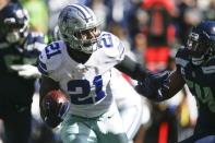 Sep 23, 2018; Seattle, WA, USA; Dallas Cowboys running back Ezekiel Elliott (21) rushes against the Seattle Seahawks during the first quarter at CenturyLink Field. Mandatory Credit: Joe Nicholson-USA TODAY Sports