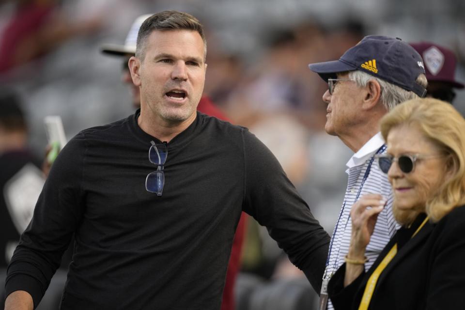 Galaxy coach Greg Vanney, left, chats with team owner Philip Anschutz and his wife, Nancy.