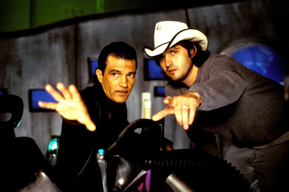 Antonio Banderas and Robert Rodriguez pointing at something off camera as they work out a scene